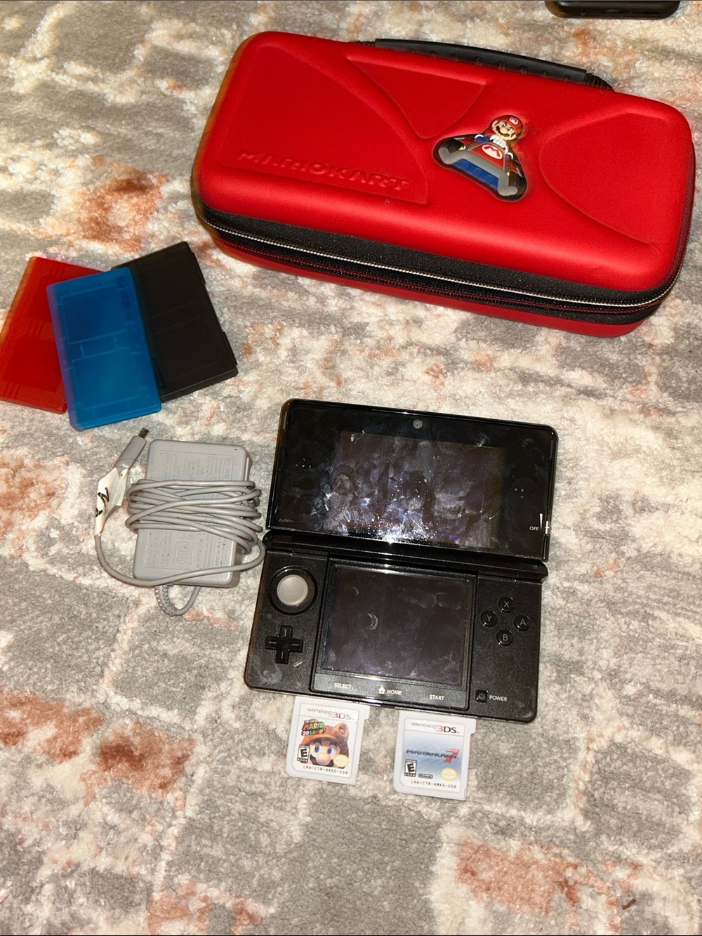 Nintendo Black Handheld Console with Red Mario Case